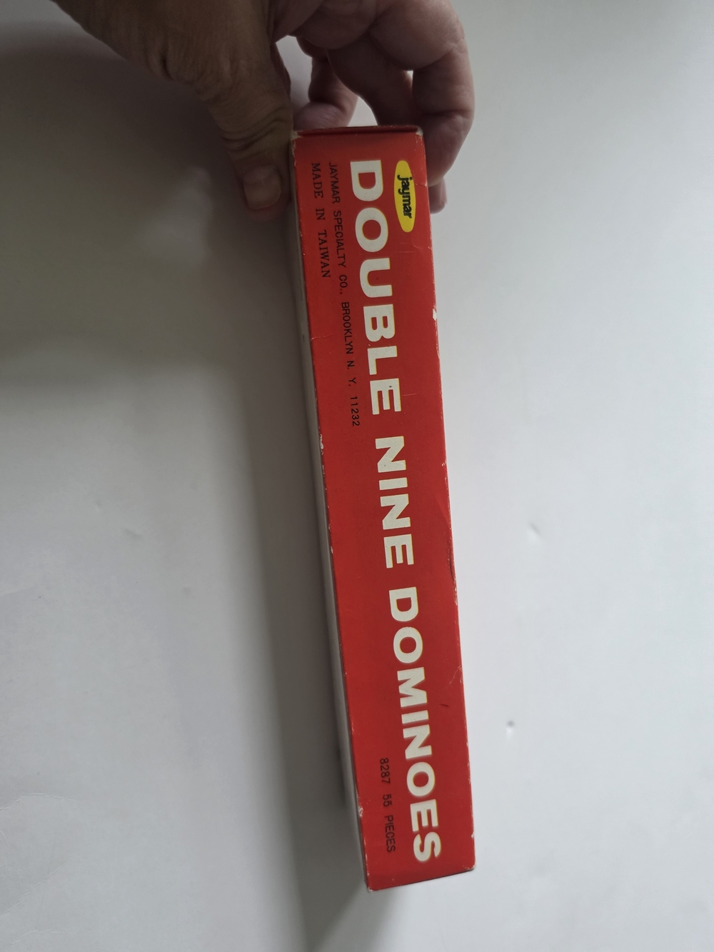 a vintage red box of Jaymar Double Nine Dominoes distributed by Woolworth.
